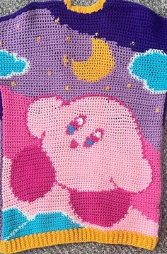 a crocheted sweater with an image of peppa pig on the front and back