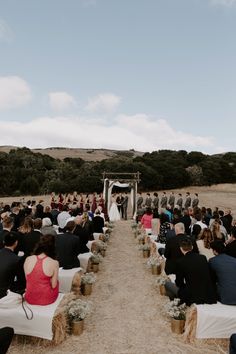 a wedding ceremony in the middle of an open field