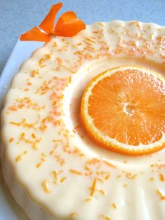 an orange slice sitting on top of a white cake