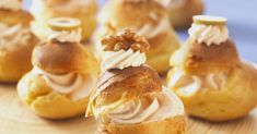 small pastries with icing on a wooden plate