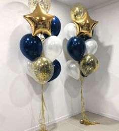 two balloons with gold and white stars on them, one is blue and the other is white