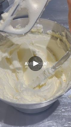 a person mixing cream in a bowl with a mixer