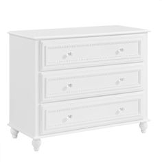 a white dresser with three drawers on it