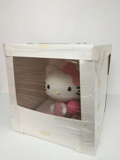 a hello kitty doll in a white box