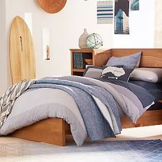 a bedroom with a surfboard on the wall