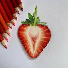 a drawing of a strawberry and some colored pencils