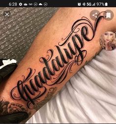 a man with a tattoo on his arm that says khaddiqe in cursive writing