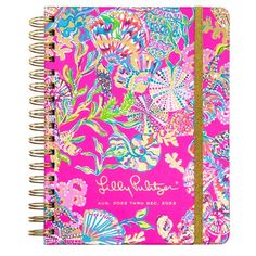 a pink notebook with colorful flowers on it