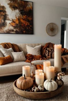 a living room filled with lots of furniture and candles on top of a coffee table