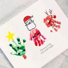 christmas handprints on a white card with santa hat and reindeer's hands