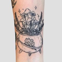 a black and white image of mushrooms in a pot on the leg with stars around it