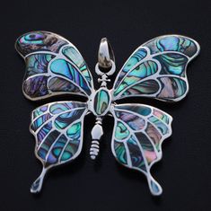 Beautiful Big butterfly silver pendant. Handmade Solid and heavy butterfly decorated with rainbow abalone shells, made from high-quality Sterling Silver 925. Native people have a myth which involves abalone shells being worn on the heads of those girls soon to become women. Not only the native Americans but the use of abalone shell can also be traced in several other native cultures worldwide. Abalone shells have been used since ancient times to increase the receptivity of the divine messages. T Handmade Silver Butterfly Necklace, Unique Silver Butterfly Pendant Necklace, Unique Handmade Silver Butterfly Necklace, Iridescent Butterfly-shaped Handmade Jewelry, Handmade Iridescent Jewelry In Butterfly Shape, Handmade Iridescent Butterfly Jewelry, Silver Butterfly Jewelry For Jewelry Making, Unique Butterfly Charm Pendant Jewelry, Silver Butterfly Charms Jewelry