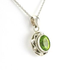 This peridot pendant was handmade in Nepal. A brilliant genuine peridot 7x9mm oval is set with sterling silver in a elegant twisted ribbon setting. Pendant is 7/8 inch long and 1/2 inch wide and is sold separate from the chain. Peridot pendant coming in a jewelry gift box. Style Number: 12064 Metal: 925 Sterling Silver Gemstone: Peridot Dimensions: 7/8 inch long and 1/2 inch wide Handmade in Nepal Peridot Pendant, Oval Pendant, Jewelry Gift Box, Nepal, Jewelry Gift, Jewelry Gifts, Gift Box, Ribbon, 925 Sterling Silver