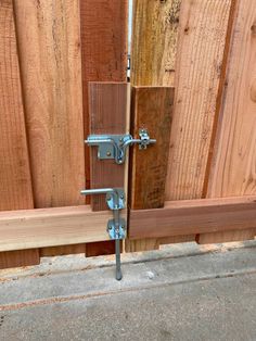 a wooden fence with metal latches on it