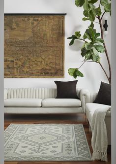 a living room filled with furniture and a large map hanging on the wall above it