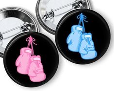 two buttons with boxing gloves on them, one is pink and the other is blue