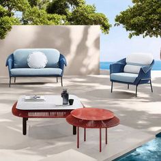 an outdoor living room with blue and red furniture