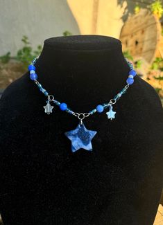 Blue starry necklace with blue and white star pendant made with polymer clay. Fits like a choker Cheap Blue Star Necklaces, Adjustable Blue Star-shaped Beaded Necklace, Blue Adjustable Star-shaped Beaded Necklaces, Adjustable Blue Beaded Star Necklaces, Blue Star Charm Pendant Necklace, Blue Star-shaped Adjustable Necklace, Handmade Blue Star-shaped Beaded Necklaces, Handmade Blue Star Beaded Necklaces, Blue Pendant Necklace With Star Charm