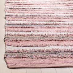 a pink and white rug on the floor