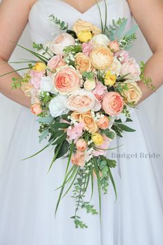 a bride holding a bouquet of flowers in her hands