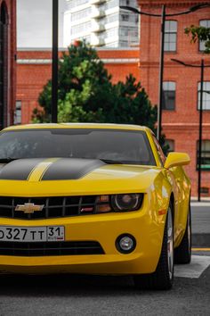 a yellow chevrolet camaro parked on the street