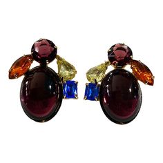 These stunning vintage earrings, reminiscent of Schreiner style, feature eye-catching rhinestones in amethyst, citrine, and sapphire. With a large oval cabochon and clip-on design, they measure approximately 1.5" in length, 1.25" in width, and 0.50" in depth. Despite light wear on the back, they are in great condition overall. Please refer to the pictures for further details and condition. Multicolor Clip-on Earrings For Formal Occasions, Vintage Jeweled Multicolor Earrings, Vintage Multicolor Jeweled Earrings, Vintage Multicolor Earrings For Evening, Vintage Multicolor Evening Earrings, Multicolor Vintage Evening Earrings, Multicolor Vintage Earrings For Evening, Multicolor 17 Jewel Earrings For Party, Vintage Purple Earrings For Party