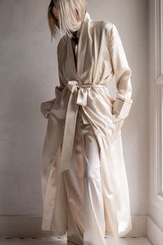 Drape yourself in opulence with the Brigitte Silk Robe. The ultimate luxury for chilly mornings or after a hot shower. 100% Silk Charmeuse Open-front robe with tie-waist Patch pockets Contrast piping 52" length (size small) Dry Clean Only All sale items are FINAL SALE. Elegant Silk Robe With Tie Waist, Elegant Wrap Robe With Tie Waist, Elegant Cream Robe With Long Sleeves, Elegant Cream Long Sleeve Robe, Elegant Spring Home Robe, Elegant Spring Robe With Tie Waist, Elegant Silk Robe For Loungewear, Elegant Formal Robe For Fall, Elegant Long Cream Robe