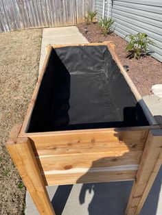 a wooden table sitting on top of a sidewalk