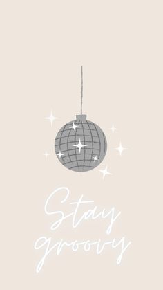 a christmas ornament with the words stay grooy on it and stars hanging from