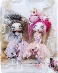 two dolls are sitting next to each other