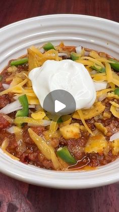 a white bowl filled with chili and cheese