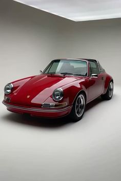 a red sports car parked in a white room