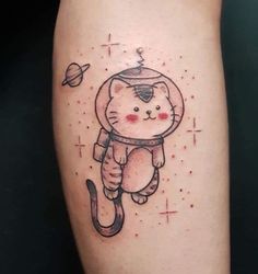 a cat in an astronaut's suit tattoo on the right leg, with space and stars around it