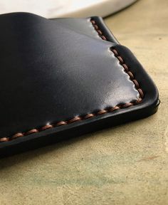 Handcrafted minimal credit card holder. Made from a single piece of 4 oz premium full-grain Burgundy #8, Brown or Black color Shell Cordovan leather from the Horween tannery. A strip of leather almost as long as the entire width of the Shell is sewn together with one thread. So this is a solid Cordovan piece and 1 thread. Sewn by hands with waxed Tiger Ritza thread. Two separate slots for 6+ plastic cards and cash. Perfect fit and small size, so this wallet will be almost invisible in your pocke Black Rectangular Card Holder With Coin Pocket, Black Bifold Card Holder For Everyday Carry, Hand-stitched Black Rectangular Wallet, Black Hand-stitched Rectangular Wallet, Black Rectangular Hand-stitched Wallets, Black Leather Wallet Hand-stitched, Black Handmade Card Holder For Daily Use, Hand-stitched Black Leather Wallet, Classic Handmade Black Wallet