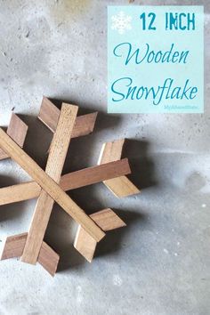 a wooden snowflake with the words 12 inch in front of it and a sign that says, wooden snowflake