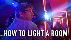 a man standing in front of a mirror holding a light up to his face with the words how to light a room