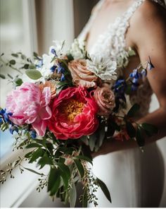 a bride holding a bouquet of flowers in her hands