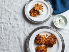 two white plates topped with food on top of a table next to a blue towel