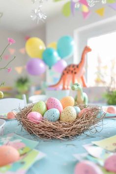 a bird's nest filled with eggs sitting on top of a blue table cloth