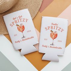 two personalized coasters sitting on top of a table next to a straw hat