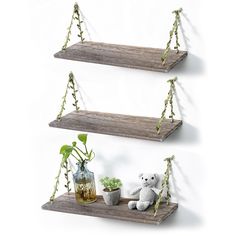 two wooden shelves with plants and teddy bears on them