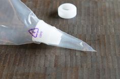 an empty plastic tube sitting on top of a wooden table