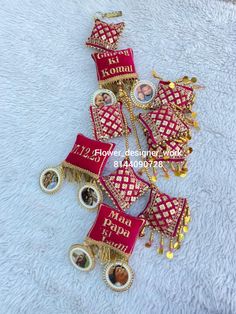 the red and gold bracelet is adorned with pictures, beads and chains that are attached to each other