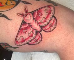 a close up of a butterfly tattoo on the back of a woman's shoulder