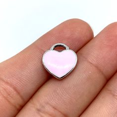 Zinc alloy pink heart charm. Pink Heart Pendant Necklace With Heart Charm, Pink Heart Beads Pendant Jewelry, Pink Heart Charms For Valentine's Day, Heart-shaped Pink Charms For Valentine's Day, Silver Heart Metal Charms, Pink Heart Beads Jewelry For Gift, Rose Gold Heart Charm For Valentine's Day, Pink Open Heart Necklace For Valentine's Day, Valentine's Day Rose Gold Heart Charm