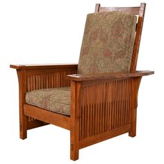 a wooden chair with an upholstered seat and arm rests against a white background