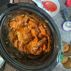 a crock pot filled with food sitting on top of a counter