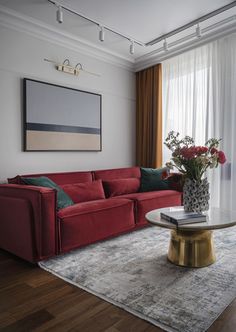 a living room with a red couch and coffee table