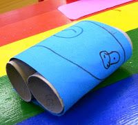 a roll of toilet paper sitting on top of a rainbow colored surface