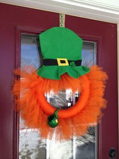 a green hat and orange tulle wreath